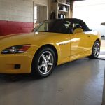 yellow sports car in garage
